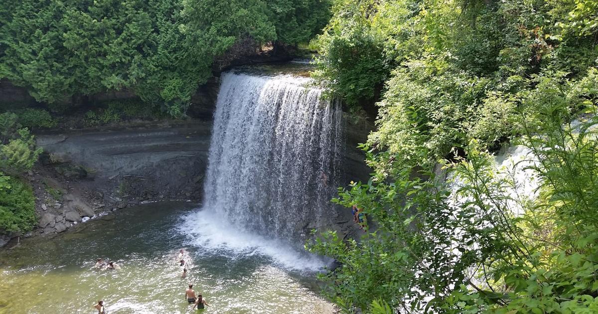 Pont suspendu rare dans le plus beau village de l'Ontario menant à la plus grande île d'eau douce du monde avec une cascade pittoresque